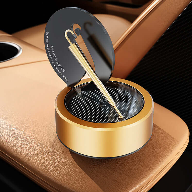 Solar rotating aromatherapy car air freshener in gold, designed for car interior with essential oil holder.