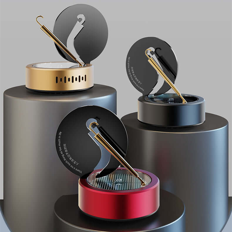 Solar rotating aromatherapy car air fresheners in obsidian black, champagne gold, and lucky red on display.